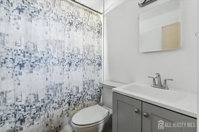 bathroom featuring vanity and toilet