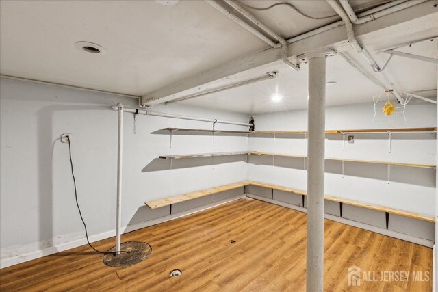 basement with hardwood / wood-style flooring