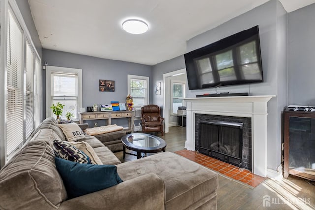 263 Bordentown Ave, South Amboy, NJ 08879 - living area featuring wood finished floors, a fireplace with flush hearth, and healthy amount of natural light