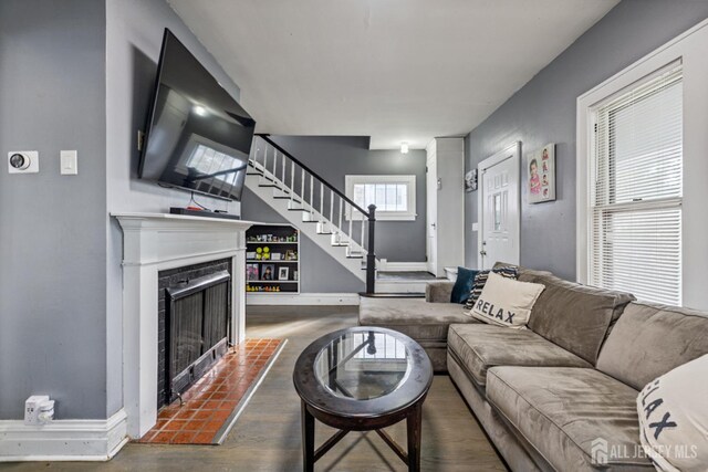 263 Bordentown Ave, South Amboy, NJ 08879 - living room with stairway, a fireplace with flush hearth, and wood finished floors