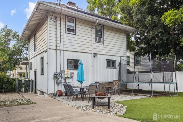 263 Bordentown Ave, South Amboy, NJ 08879 - rear view of property featuring a trampoline and a patio area