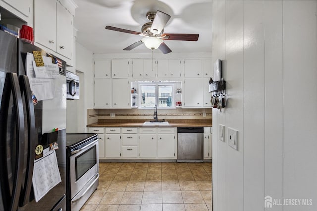 263 Bordentown Ave, South Amboy, NJ 08879 - kitchen with appliances with stainless steel finishes, white cabinetry, a ceiling fan, and dark countertops