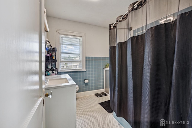 263 Bordentown Ave, South Amboy, NJ 08879 - full bathroom featuring tile walls, vanity, tile patterned floors, wainscoting, and curtained shower