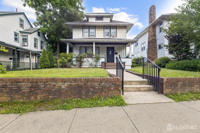 263 Bordentown Ave, South Amboy, NJ 08879 - american foursquare style home with board and batten siding, covered porch, and a front yard