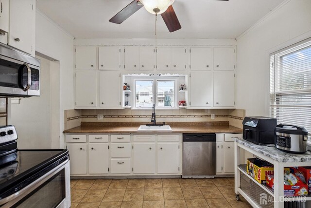 263 Bordentown Ave, South Amboy, NJ 08879 - kitchen featuring appliances with stainless steel finishes, ceiling fan, white cabinets, light tile patterned floors, and open shelves