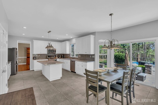 4 Angelina Ct, Monroe, NJ 08831 - kitchen featuring stainless steel appliances, decorative backsplash, light tile patterned floors, a center island, and recessed lighting