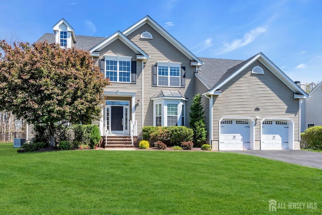 4 Angelina Ct, Monroe, NJ 08831 - view of front of house featuring a front yard, asphalt driveway, a shingled roof, central air condition unit, and a garage