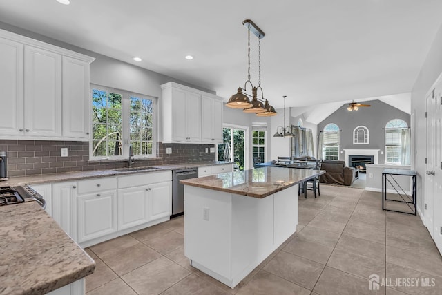 4 Angelina Ct, Monroe, NJ 08831 - kitchen with a sink, stainless steel dishwasher, open floor plan, a center island, and a glass covered fireplace