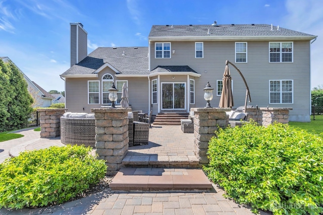 4 Angelina Ct, Monroe, NJ 08831 - back of property featuring a patio area, a chimney, roof with shingles, and entry steps