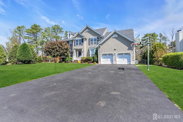 4 Angelina Ct, Monroe, NJ 08831 - view of front facade with driveway, a front yard, and an attached garage