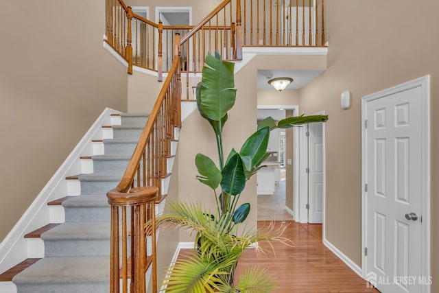 4 Angelina Ct, Monroe, NJ 08831 - staircase featuring a high ceiling, baseboards, and wood finished floors