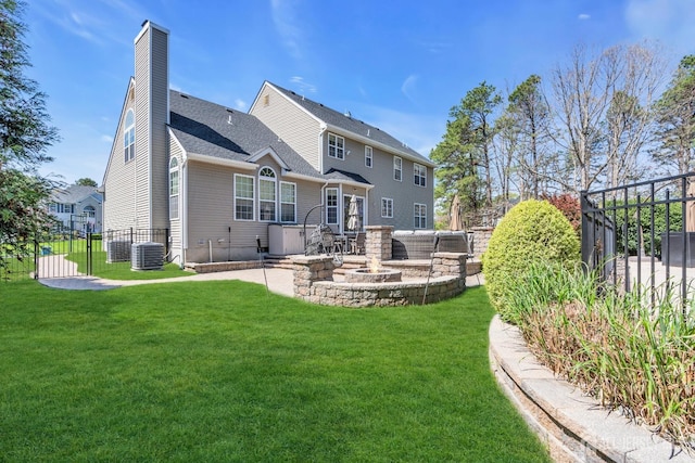 4 Angelina Ct, Monroe, NJ 08831 - back of property featuring a chimney, a patio area, a fire pit, and central air condition unit