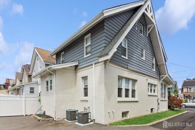 147 Grove Ave, Woodbridge Proper, NJ 07095 - view of side of property featuring stucco siding and a shingled roof