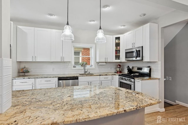 147 Grove Ave, Woodbridge Proper, NJ 07095 - kitchen featuring stainless steel appliances, white cabinets, tasteful backsplash, and light stone countertops