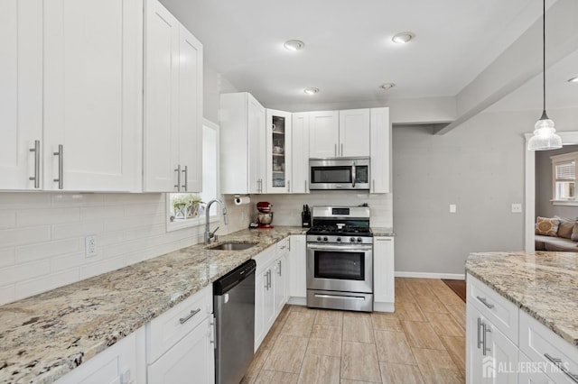 147 Grove Ave, Woodbridge Proper, NJ 07095 - kitchen with appliances with stainless steel finishes, white cabinets, glass insert cabinets, decorative backsplash, and recessed lighting