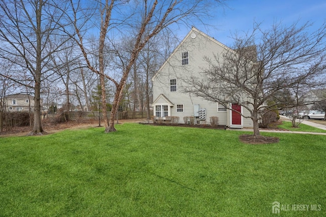 view of home's exterior featuring a yard and fence