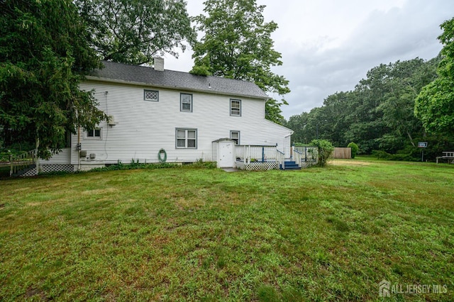 45 Lake Ave, Helmetta, NJ 08828 - rear view of property with a deck, a yard, and a chimney