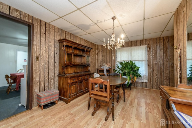 45 Lake Ave, Helmetta, NJ 08828 - dining space featuring a paneled ceiling, light wood finished floors, a chandelier, and wood walls