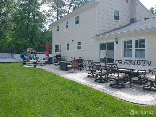 18 Timber Rd, East Brunswick, NJ 08816 - rear view of house featuring a trampoline, a patio, a playground, and a shingled roof