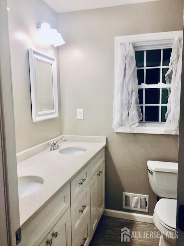 18 Timber Rd, East Brunswick, NJ 08816 - bathroom featuring double vanity, toilet, and baseboards