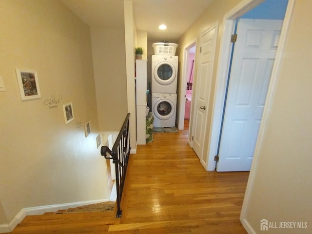 18 Timber Rd, East Brunswick, NJ 08816 - hallway with stacked washer / dryer, light wood finished floors, an upstairs landing, and baseboards