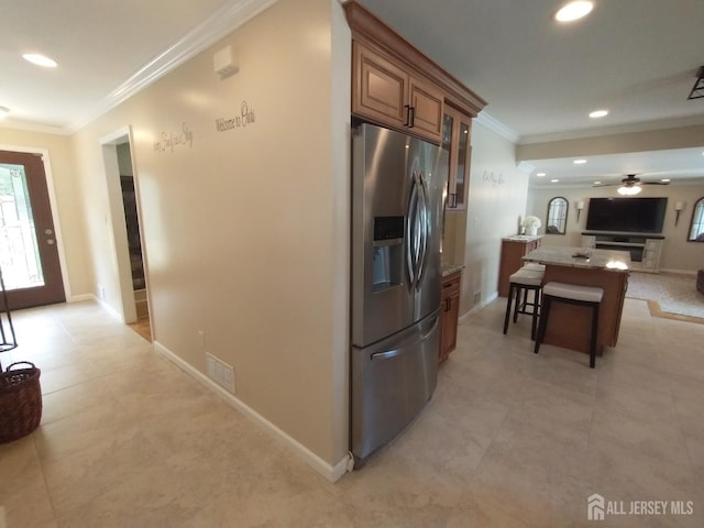 18 Timber Rd, East Brunswick, NJ 08816 - kitchen featuring stainless steel refrigerator with ice dispenser, ornamental molding, brown cabinets, a ceiling fan, and glass insert cabinets