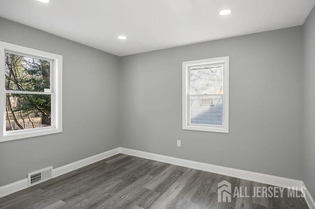 empty room featuring dark hardwood / wood-style flooring