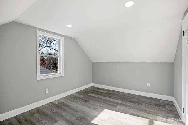 bonus room with vaulted ceiling and dark hardwood / wood-style flooring