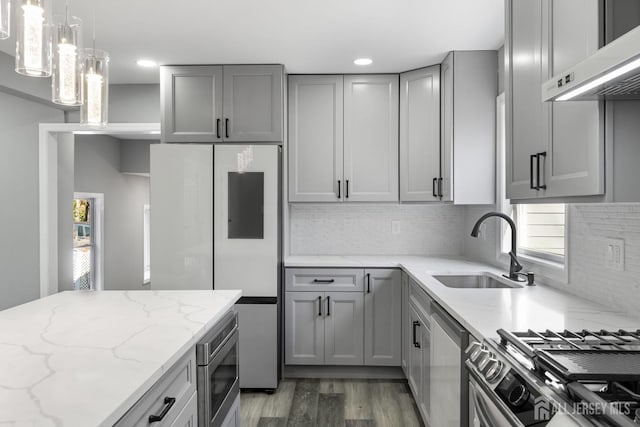 kitchen with sink, gray cabinetry, ventilation hood, and stainless steel appliances