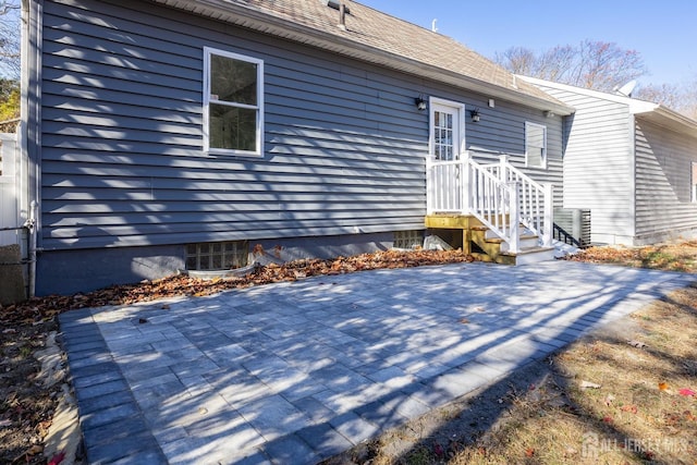 view of exterior entry with a patio area