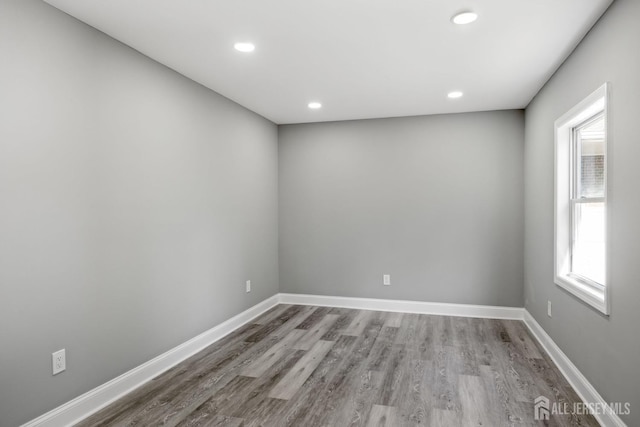 unfurnished room with light wood-type flooring