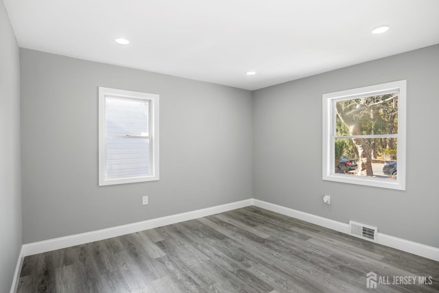 unfurnished room with hardwood / wood-style flooring