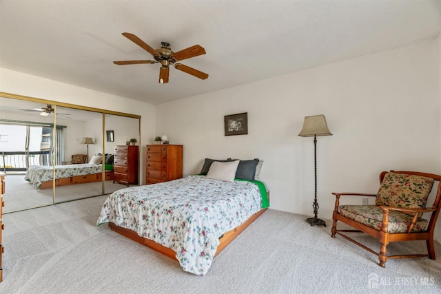 bedroom featuring ceiling fan, a closet, and carpet