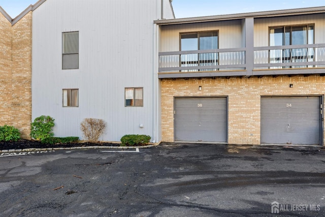 view of front of home featuring a garage and a balcony