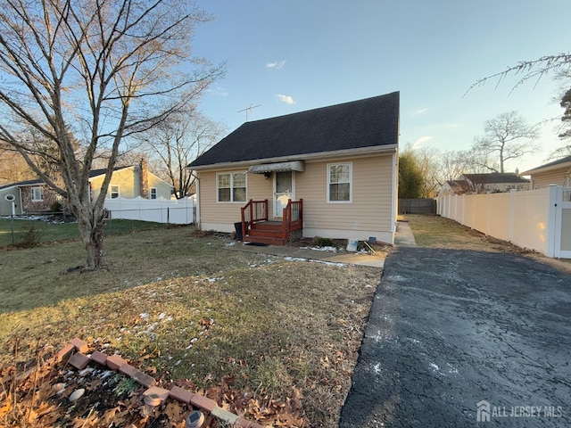 bungalow-style house with a front lawn