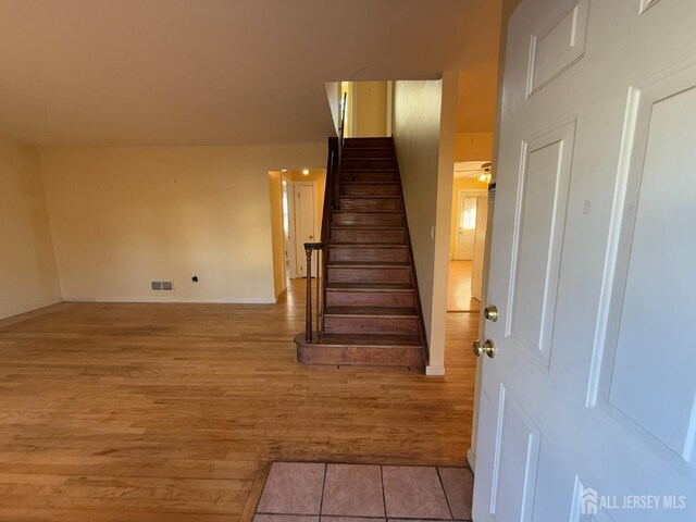 staircase featuring tile patterned floors