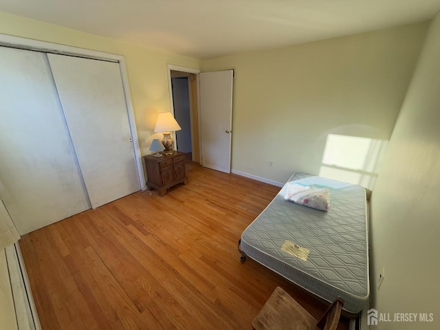 bedroom featuring a closet and light wood-type flooring