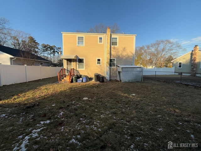 rear view of house with a yard