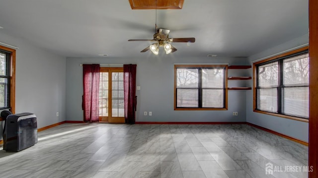 unfurnished room with visible vents, ceiling fan, and baseboards