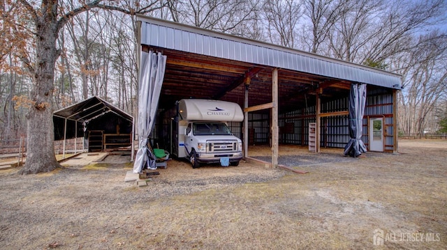 view of pole building featuring driveway and a carport