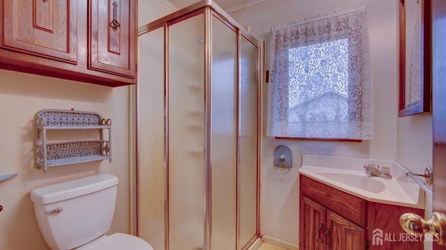 full bathroom featuring toilet, a stall shower, and vanity