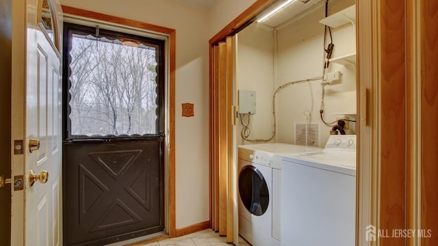 laundry area with baseboards, laundry area, and washer and dryer