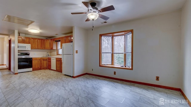 kitchen featuring white appliances, baseboards, visible vents, light countertops, and a sink