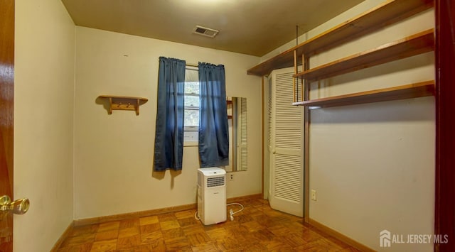 unfurnished bedroom featuring visible vents and baseboards