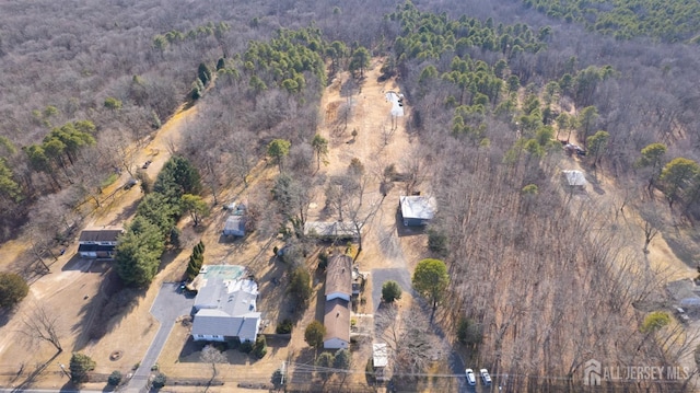 birds eye view of property featuring a view of trees