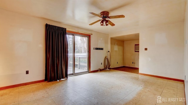 spare room with light floors, a ceiling fan, and baseboards