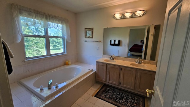 bathroom with vanity, tile patterned flooring, and a relaxing tiled tub