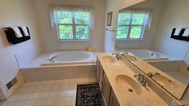 bathroom featuring tiled bath, tile patterned floors, and vanity