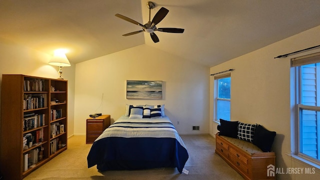 carpeted bedroom featuring ceiling fan and vaulted ceiling