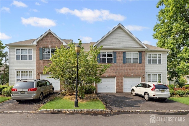 302 Berkshire Dr, South Brunswick, NJ 08540 - view of front of home with driveway, an attached garage, and brick siding